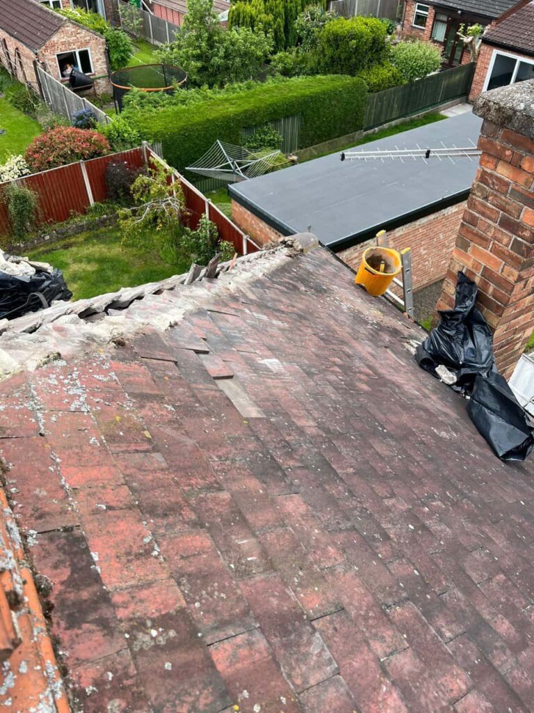 This is a photo of a roof where the hip tiles have been removed, and are just about to be replaced. Works carried out by MCM Roofing Repairs Sherborne