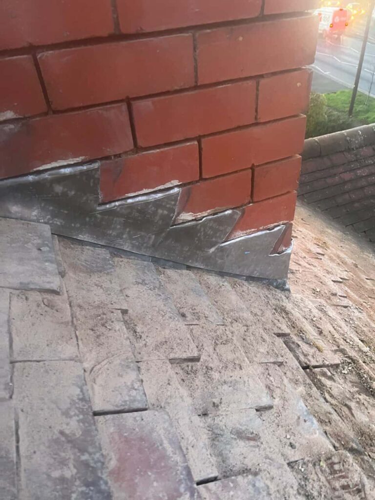 This is a photo of new leadwork being installed around an old chimney. Works carried out by MCM Roofing Repairs Sherborne
